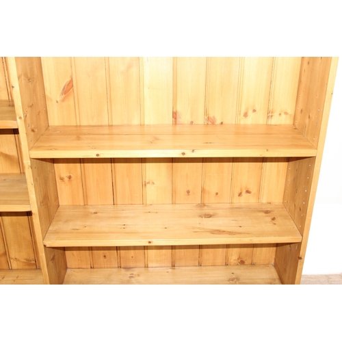 143 - A modern pine bookcase with 2 sections and 4 adjustable shelves, approx 180cm wide x 26cm deep x 123... 