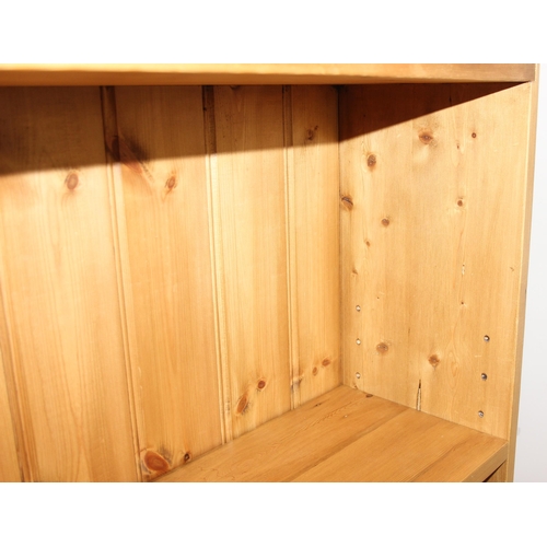 143 - A modern pine bookcase with 2 sections and 4 adjustable shelves, approx 180cm wide x 26cm deep x 123... 