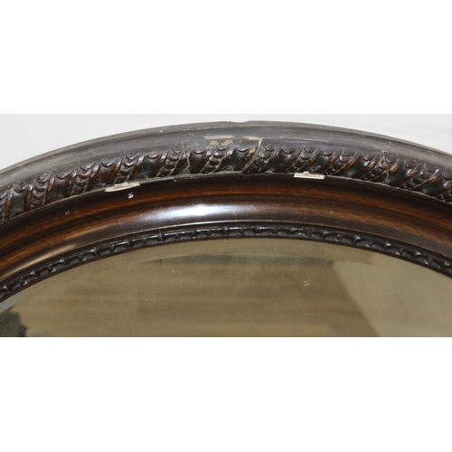 361 - A vintage oval shaped wooden effect wall mirror, approx 95cm x 70cm