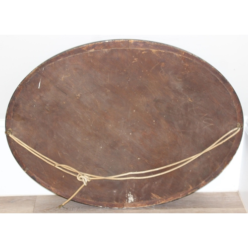 361 - A vintage oval shaped wooden effect wall mirror, approx 95cm x 70cm