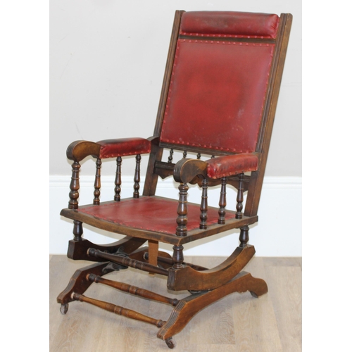 173 - An antique rocking chair with red leather effect upholstery, possibly American, approx 55cm wide x 1... 