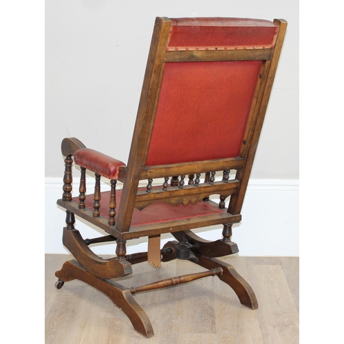 173 - An antique rocking chair with red leather effect upholstery, possibly American, approx 55cm wide x 1... 