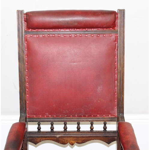 173 - An antique rocking chair with red leather effect upholstery, possibly American, approx 55cm wide x 1... 