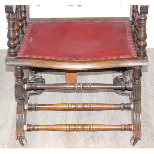 173 - An antique rocking chair with red leather effect upholstery, possibly American, approx 55cm wide x 1... 