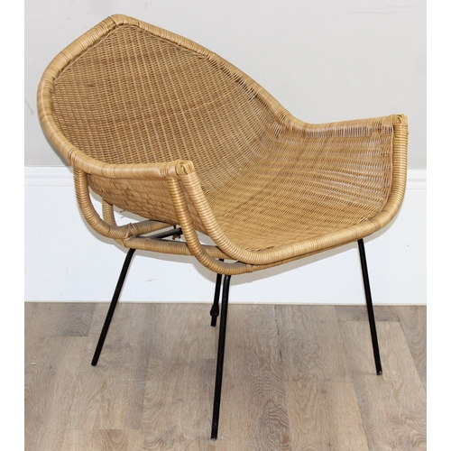 148 - A retro wicker armchair with black painted metal legs and unusual shaped seat, approx 65cm wide x 76... 