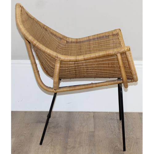 148 - A retro wicker armchair with black painted metal legs and unusual shaped seat, approx 65cm wide x 76... 