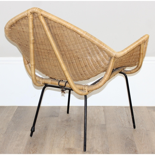 148 - A retro wicker armchair with black painted metal legs and unusual shaped seat, approx 65cm wide x 76... 