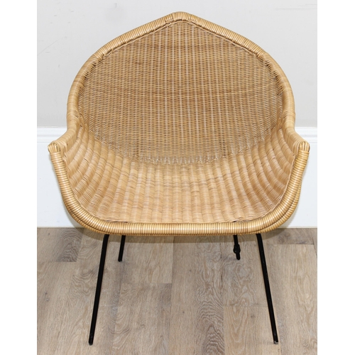 148 - A retro wicker armchair with black painted metal legs and unusual shaped seat, approx 65cm wide x 76... 