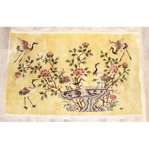 203 - Silk Rugs - a vintage Chinese hand knotted thick pile rug of yellow ground decorated with storks or ... 