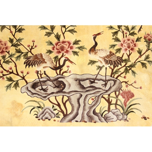 203 - Silk Rugs - a vintage Chinese hand knotted thick pile rug of yellow ground decorated with storks or ... 