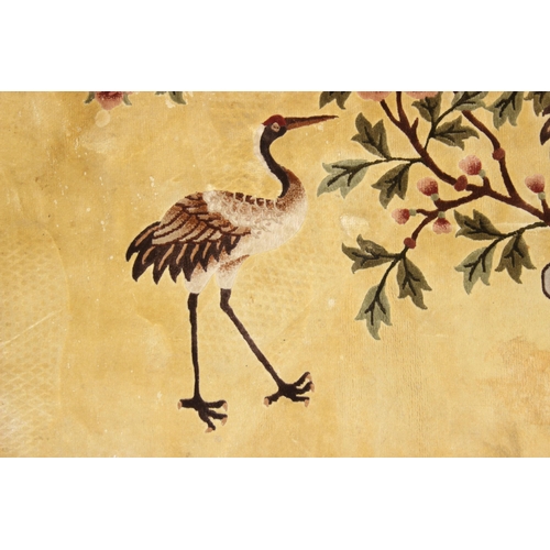 203 - Silk Rugs - a vintage Chinese hand knotted thick pile rug of yellow ground decorated with storks or ... 