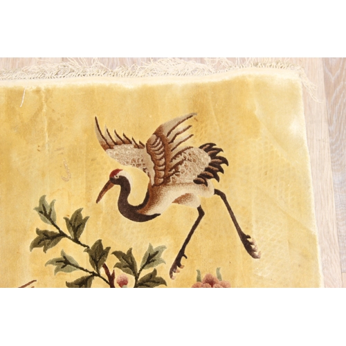 203 - Silk Rugs - a vintage Chinese hand knotted thick pile rug of yellow ground decorated with storks or ... 