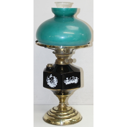 245 - A vintage oil lamp with brass base, black printed glass reservoir and green glass shade, approx 55cm... 