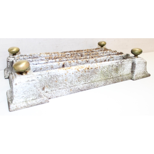 303 - Weathered cast iron boot scraper with brass adornments, approx 47cm x 27cm