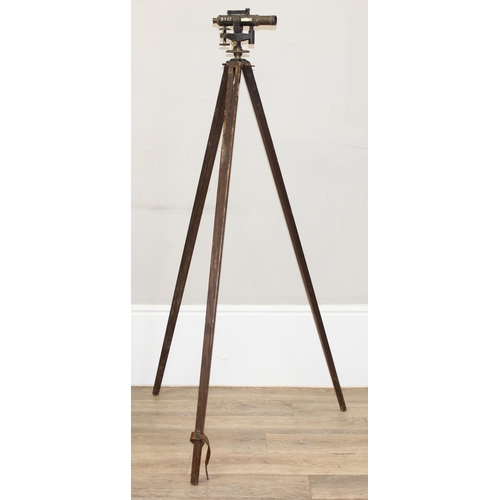 727 - A vintage painted brass theodolite on wooden tripod base, both seemingly unmarked, approx 145cm tall... 