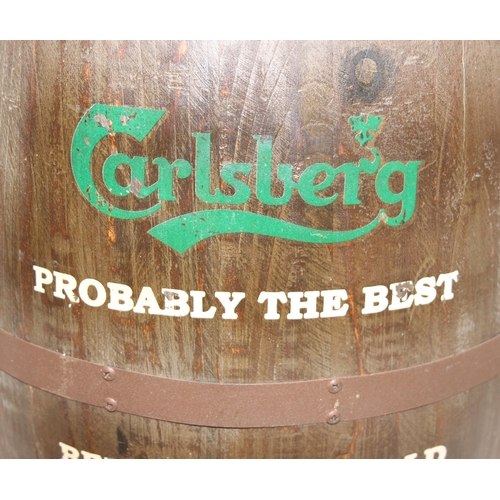 166 - A vintage style barrel formed stool with faux leather button top and Carlsberg related advertising, ... 