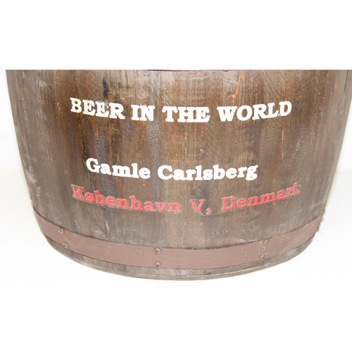 166 - A vintage style barrel formed stool with faux leather button top and Carlsberg related advertising, ... 