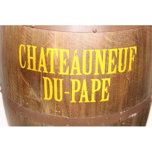 167 - A vintage style barrel formed stool with faux leather button top and Chateauneuf Du-Pape related adv... 