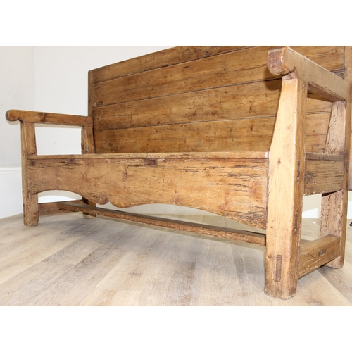 4 - An antique rustic pine high backed bench or settle, approx 175cm wide x 70cm deep x 105cm tall