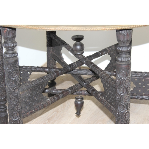 163 - A vintage brass topped folding Benares tray topped table, approx 75cm in diameter x 54cm tall