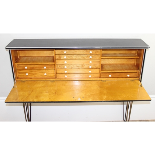 32 - An unusual retro desk type sideboard with black Formica top and metal hairpin legs, fold down front ... 