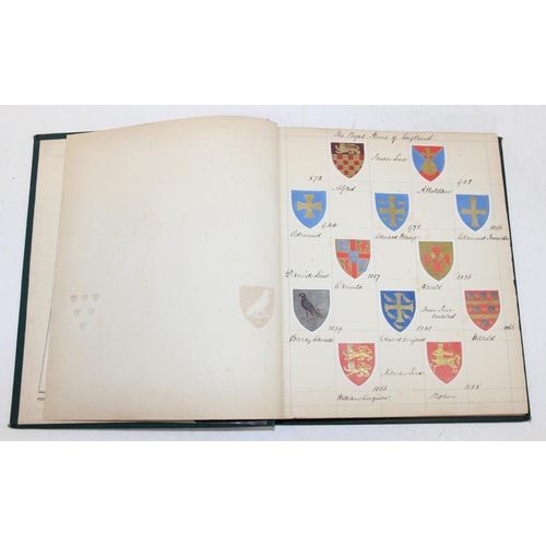 534 - An antique highly decorative cloth bound book containing a large qty of embossed arms crests and mon... 