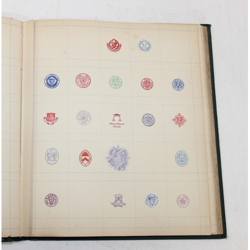 534 - An antique highly decorative cloth bound book containing a large qty of embossed arms crests and mon... 