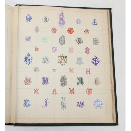 534 - An antique highly decorative cloth bound book containing a large qty of embossed arms crests and mon... 