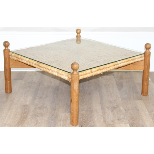 133 - A retro style X-framed light oak based coffee table with woven reed and glass top, approx 70cm squar... 