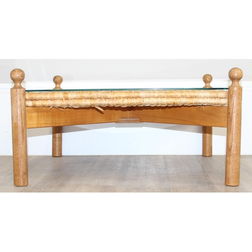 133 - A retro style X-framed light oak based coffee table with woven reed and glass top, approx 70cm squar... 