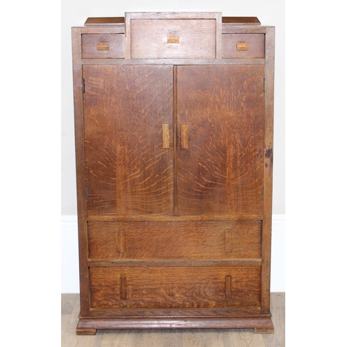 69 - An Art Deco period oak side cabinet with 3 stepped drawers over 2 cupboards over 2 further drawers, ... 