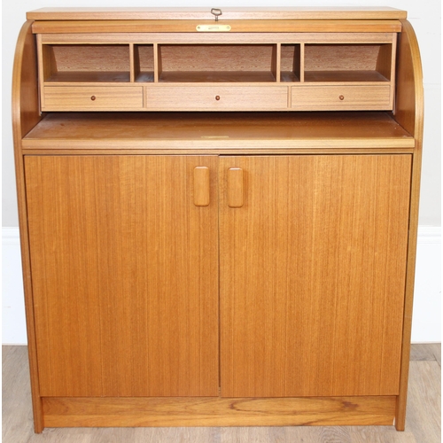 29 - A retro Swedish drum topped bureau by SMI (Sveriges Möbelindustriförbund), the roll top housing a nu... 