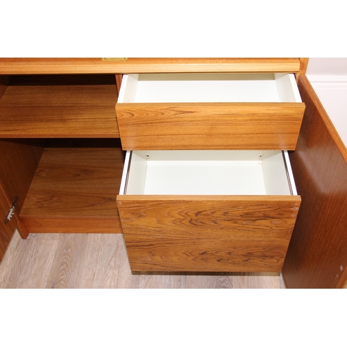 29 - A retro Swedish drum topped bureau by SMI (Sveriges Möbelindustriförbund), the roll top housing a nu... 