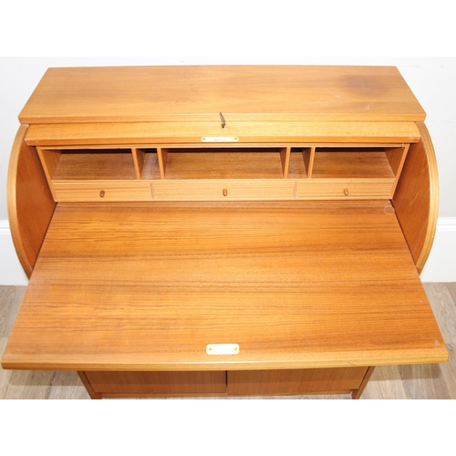 29 - A retro Swedish drum topped bureau by SMI (Sveriges Möbelindustriförbund), the roll top housing a nu... 