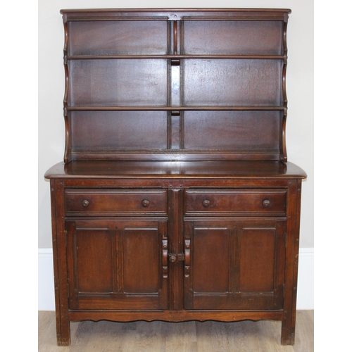 58 - A vintage oak dresser or sideboard, likely Ercol or Old Charm but seemingly unmarked, approx 123cm w... 