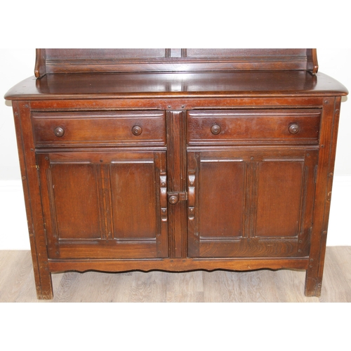 58 - A vintage oak dresser or sideboard, likely Ercol or Old Charm but seemingly unmarked, approx 123cm w... 