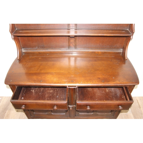 58 - A vintage oak dresser or sideboard, likely Ercol or Old Charm but seemingly unmarked, approx 123cm w... 