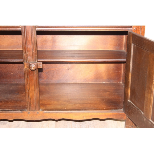 58 - A vintage oak dresser or sideboard, likely Ercol or Old Charm but seemingly unmarked, approx 123cm w... 