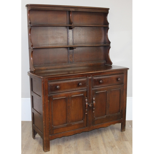 58 - A vintage oak dresser or sideboard, likely Ercol or Old Charm but seemingly unmarked, approx 123cm w... 