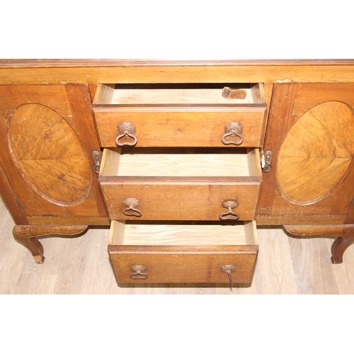 111 - A vintage oak sideboard with 3 drawers flanked by 2 cupboards, early 20th century, approx 121cm wide... 