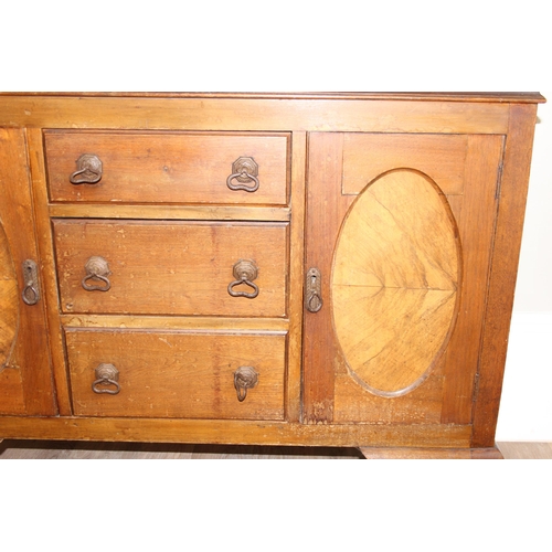 111 - A vintage oak sideboard with 3 drawers flanked by 2 cupboards, early 20th century, approx 121cm wide... 