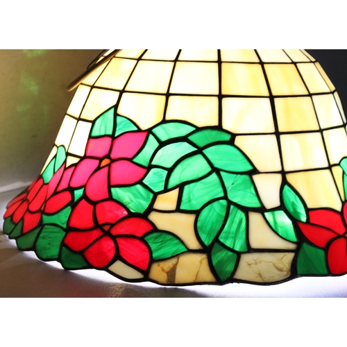 255 - A large Tiffany style leaded glass lamp shade decorated with red flowers, approx 48cm wide