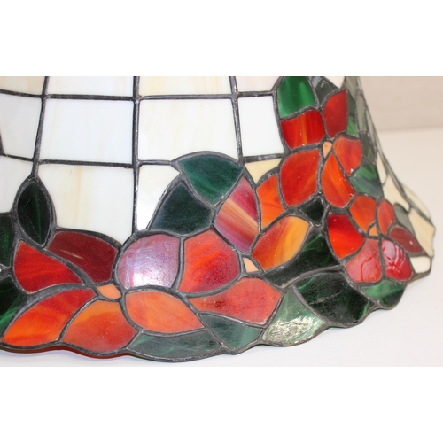 255 - A large Tiffany style leaded glass lamp shade decorated with red flowers, approx 48cm wide