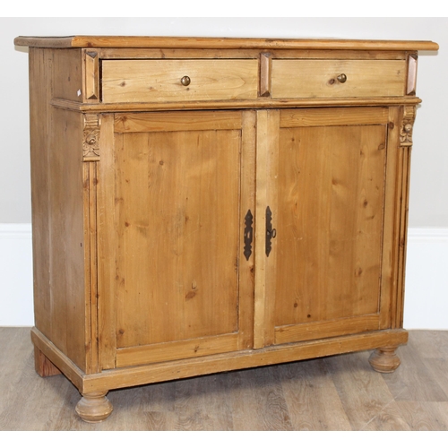 10 - A vintage pine 2 drawer and 2 door sideboard with carved pillar sides, approx 109cm wide x 51cm x 10... 