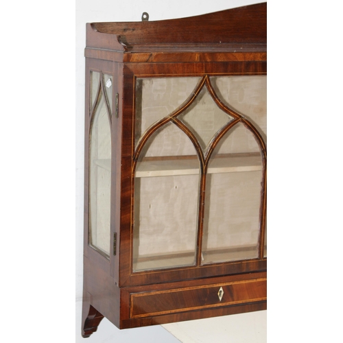 64 - An unusual antique mahogany wall-mountable Gothic style glazed cabinet with three drawers and inlaid... 