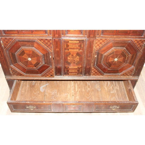 19 - An extremely unusual antique cupboard with single drawer to base and geometric parquetry design, bel... 