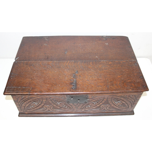 279 - An antique oak bible box with carved details and iron lock and hinges, carved details include the in... 