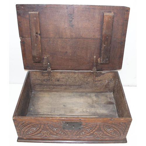 279 - An antique oak bible box with carved details and iron lock and hinges, carved details include the in... 