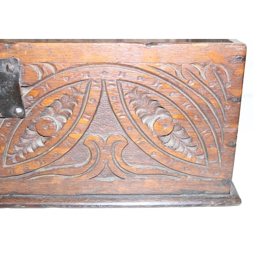 279 - An antique oak bible box with carved details and iron lock and hinges, carved details include the in... 