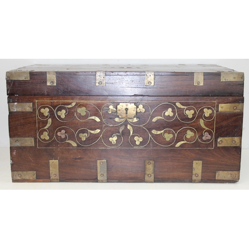 280 - An Anglo-Indian carved hardwood and brass mounted trunk with side carrying handles and fitted interi... 